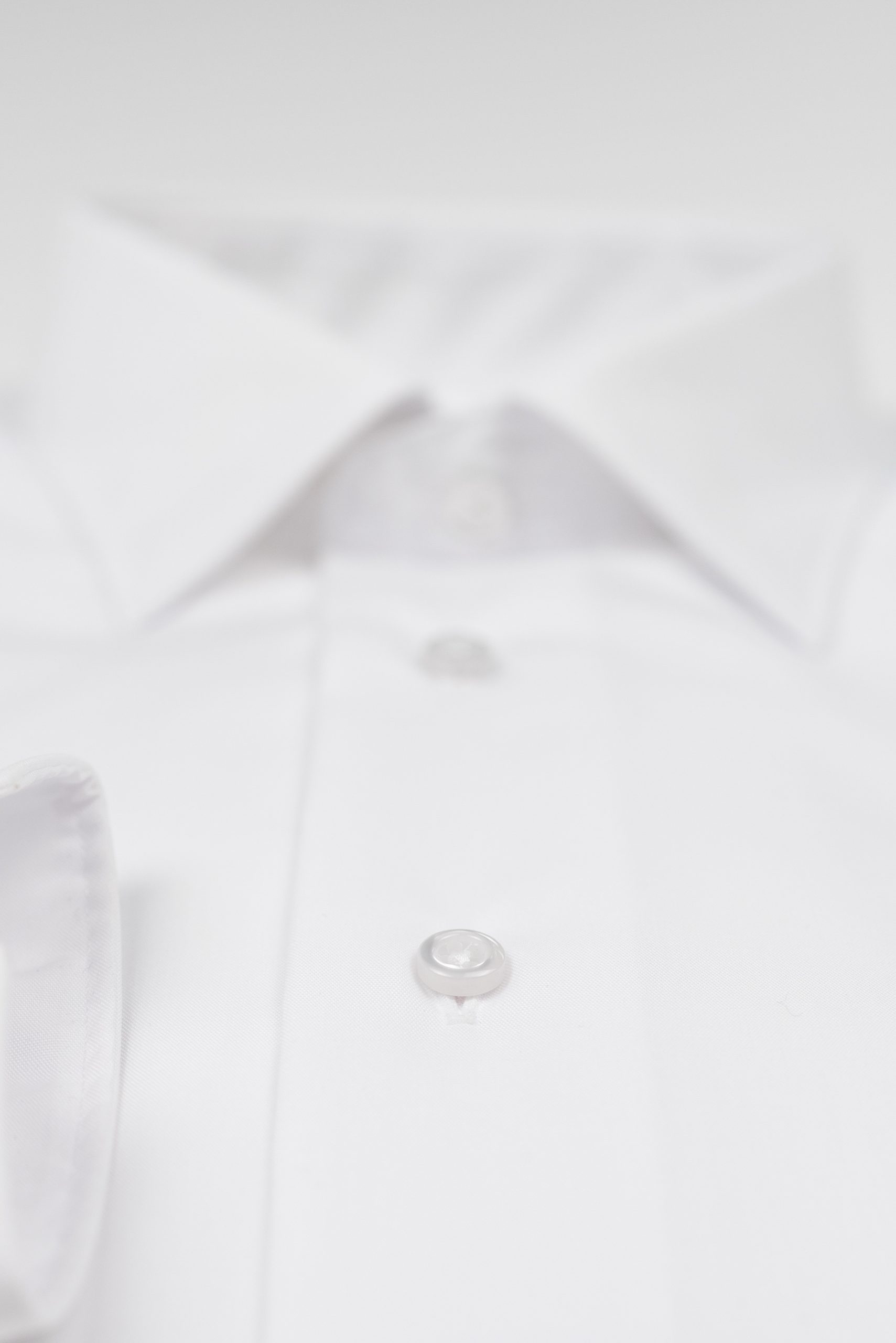 a close up of a button on a white shirt