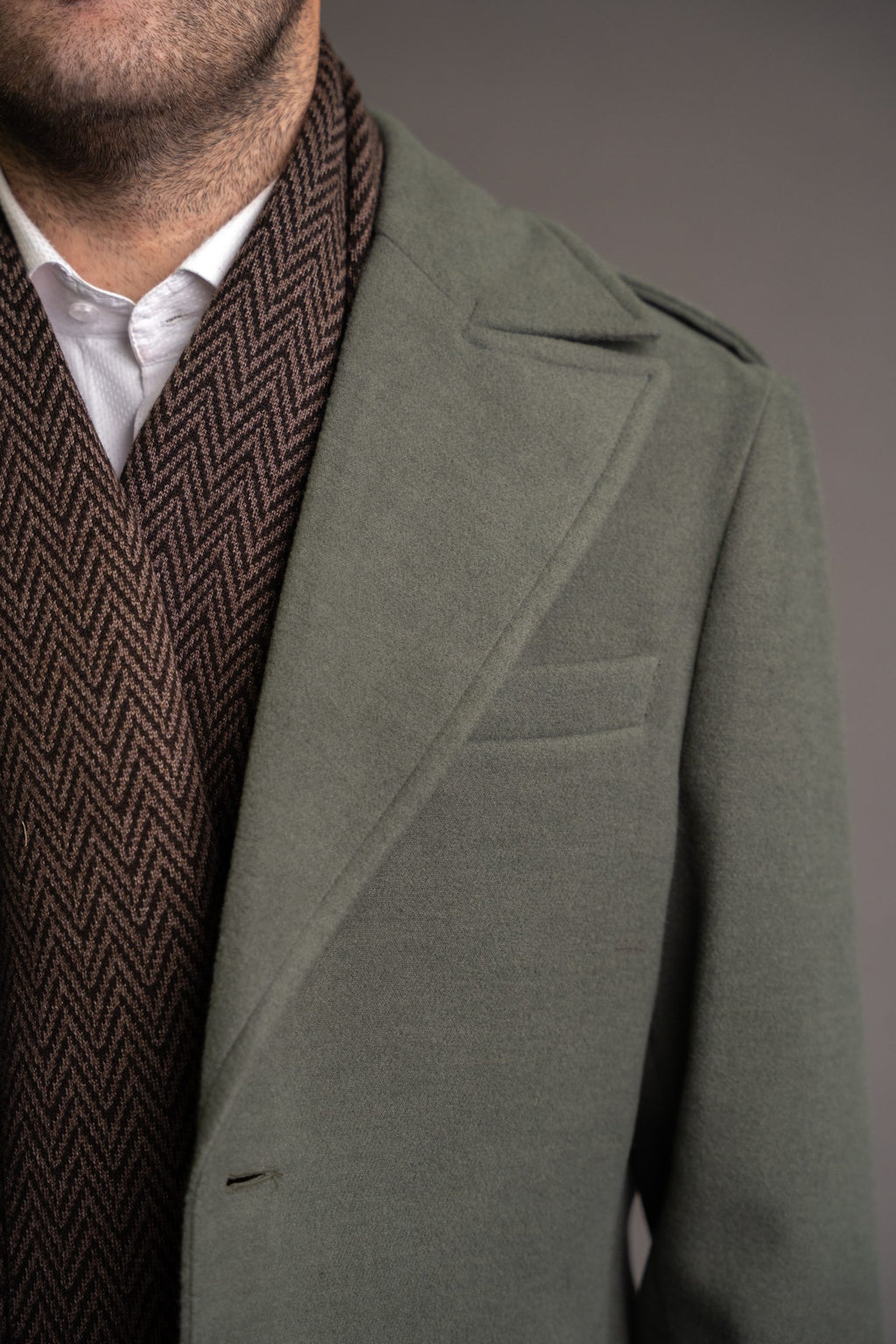 Men's green army-style winter coat by Quiet Luxury, stylish and warm, shown on a mannequin with a tailored fit.