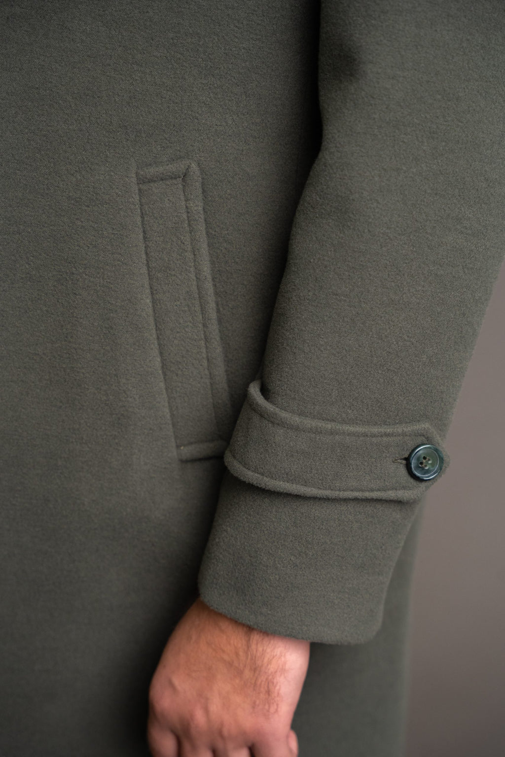 Men's green army-style winter coat by Quiet Luxury, tailored fit with button closure and stylish collar, designed for cold weather.