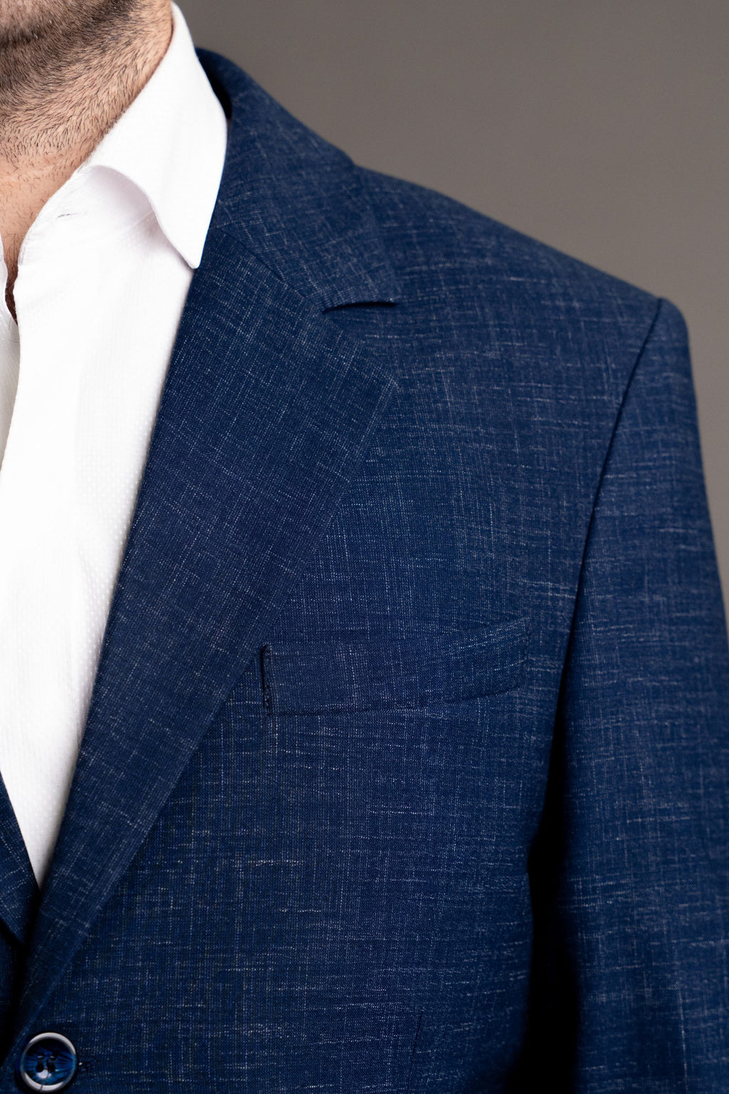 Navy textured suit jacket by Couture for Gentlemen, featuring tailored design and subtle fabric details.