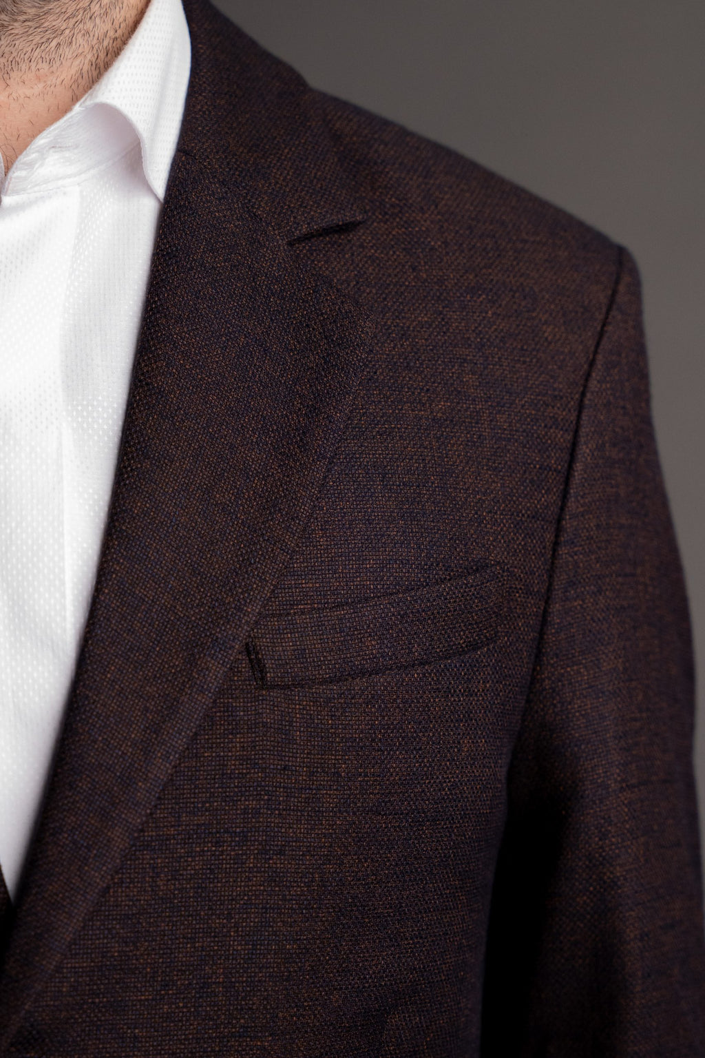 Maroon men's suit jacket from CoutureforGentlemen, tailored fit, with lapels and button details, shown on a hanger.