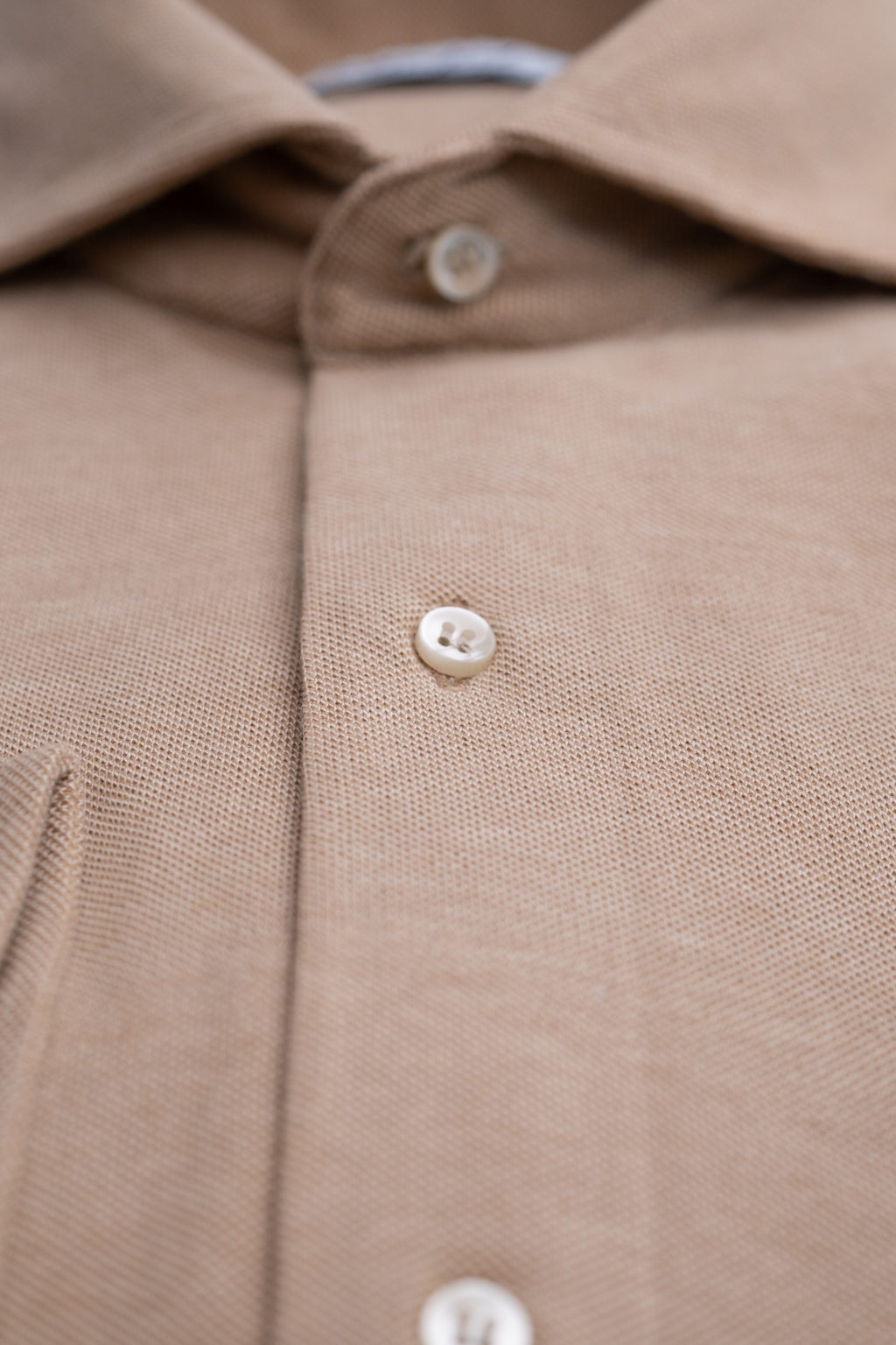 Beige men's shirt from Sthenford CMS02BJS by Couture for Gentlemen, shown on a hanger with detailed fabric texture.