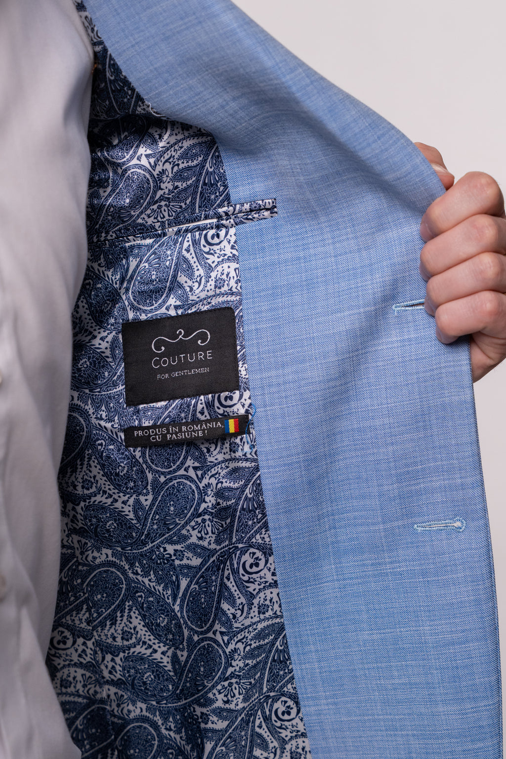Light blue Tailored Fit Tinuta Solaro suit by Couture for Gentlemen, shown on a hanger against a neutral background.