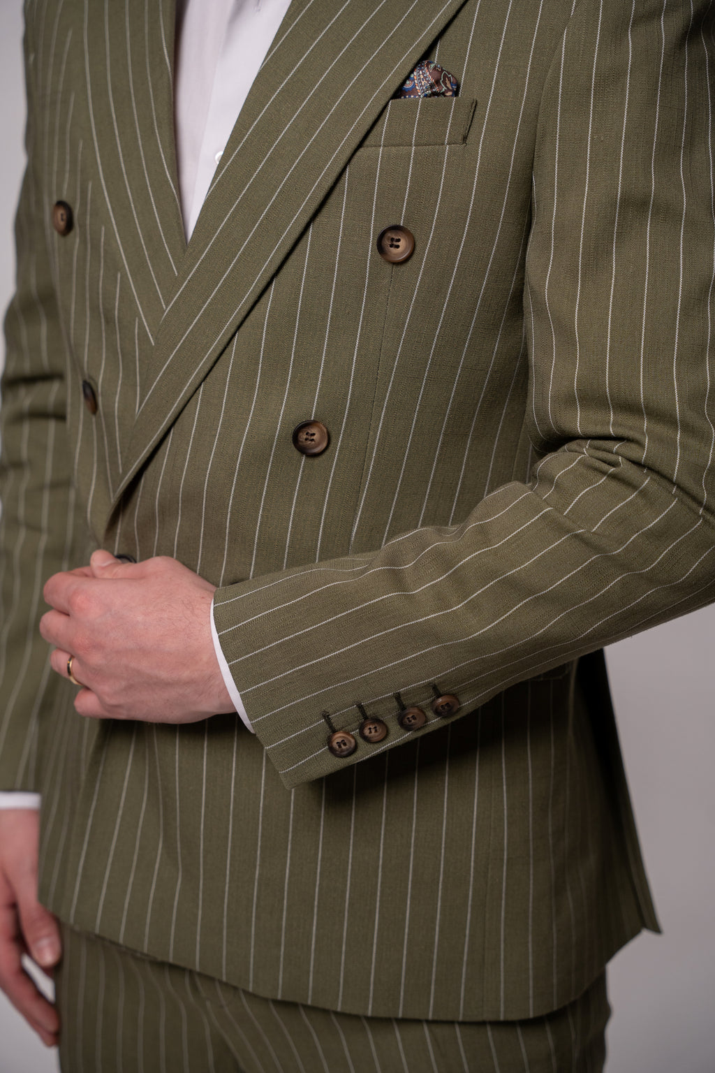 Olive green men's double-breasted linen blazer with striped pattern, featuring two rows of buttons, from Couture for Gentlemen.