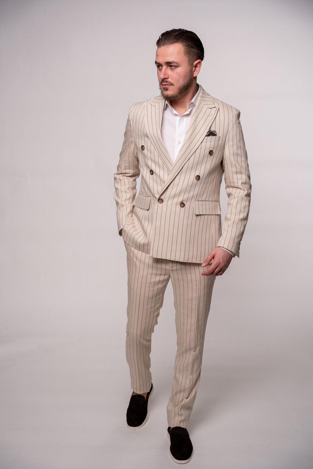 Beige men's linen blazer with two rows of buttons, featuring striped pattern, stylish and tailored for a sophisticated look.