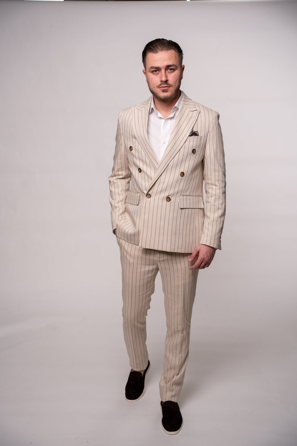 Beige men's linen blazer with two rows of buttons, featuring striped pattern and tailored fit, from Couture for Gentlemen.