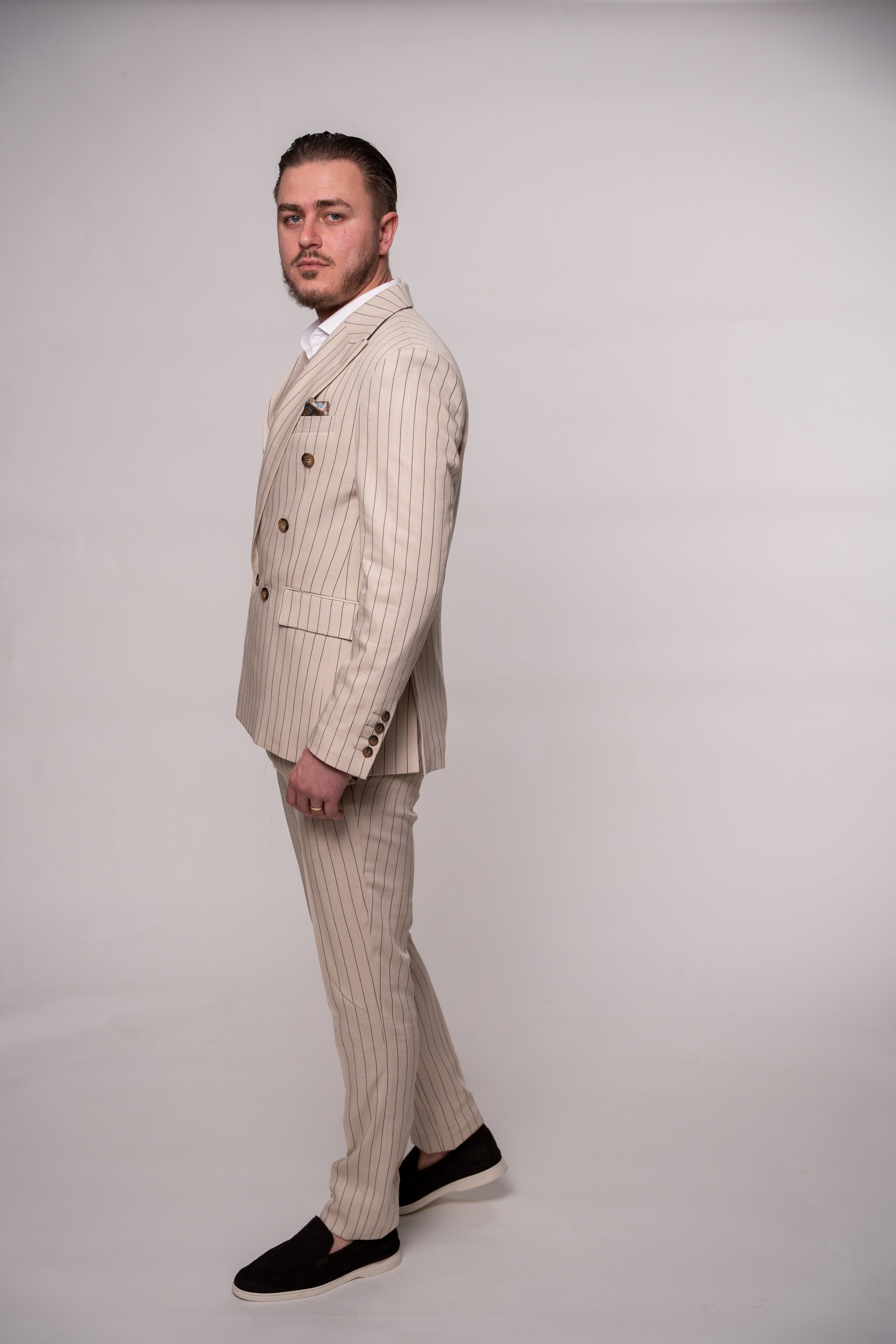 Beige linen men's blazer with two rows of buttons, featuring striped pattern, stylish and tailored for a sophisticated look.