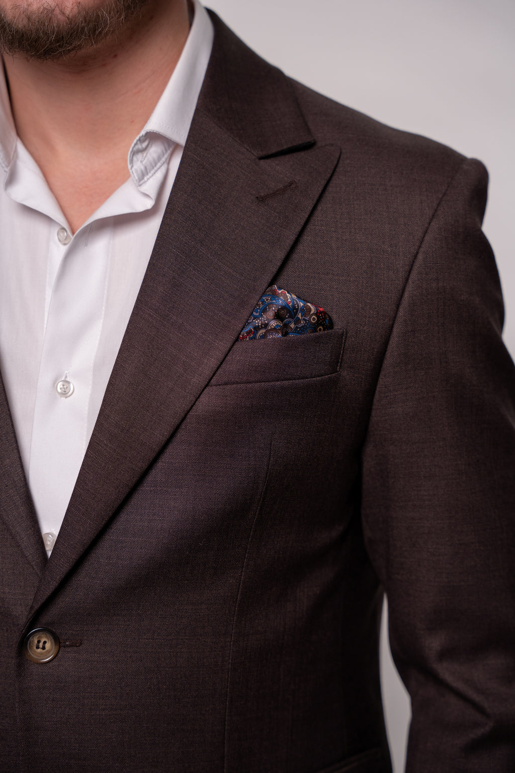 Chocolate brown Napoli costume for men, tailored fit, stylish lapels, and button details, ideal for formal occasions.
