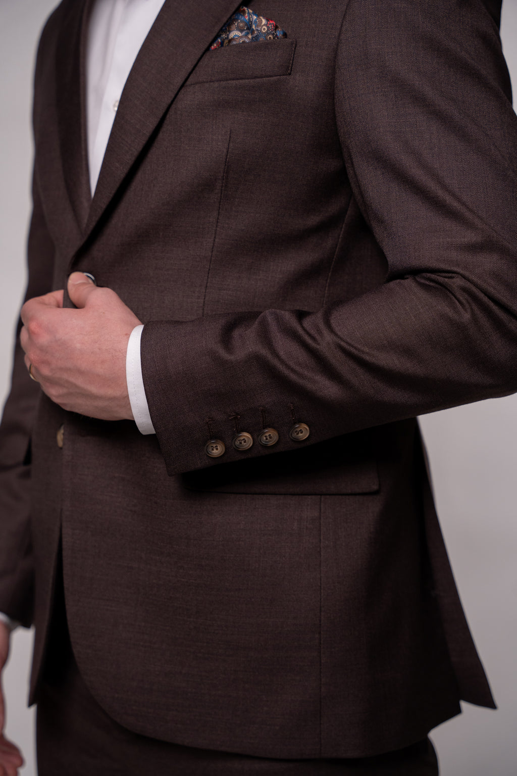 Chocolate brown Napoli costume for men, tailored fit with classic lapels, shown in a formal setting.