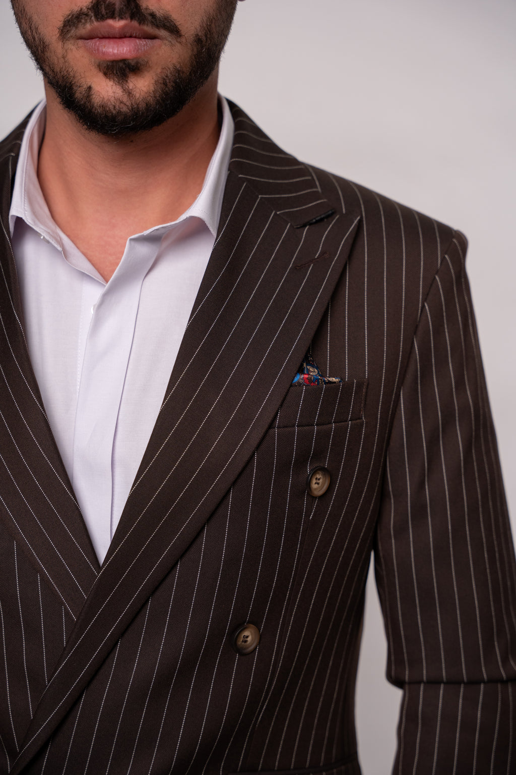 Maroon and white striped two-row button costume from Couture for Gentlemen, detailed fabric texture and classic style.