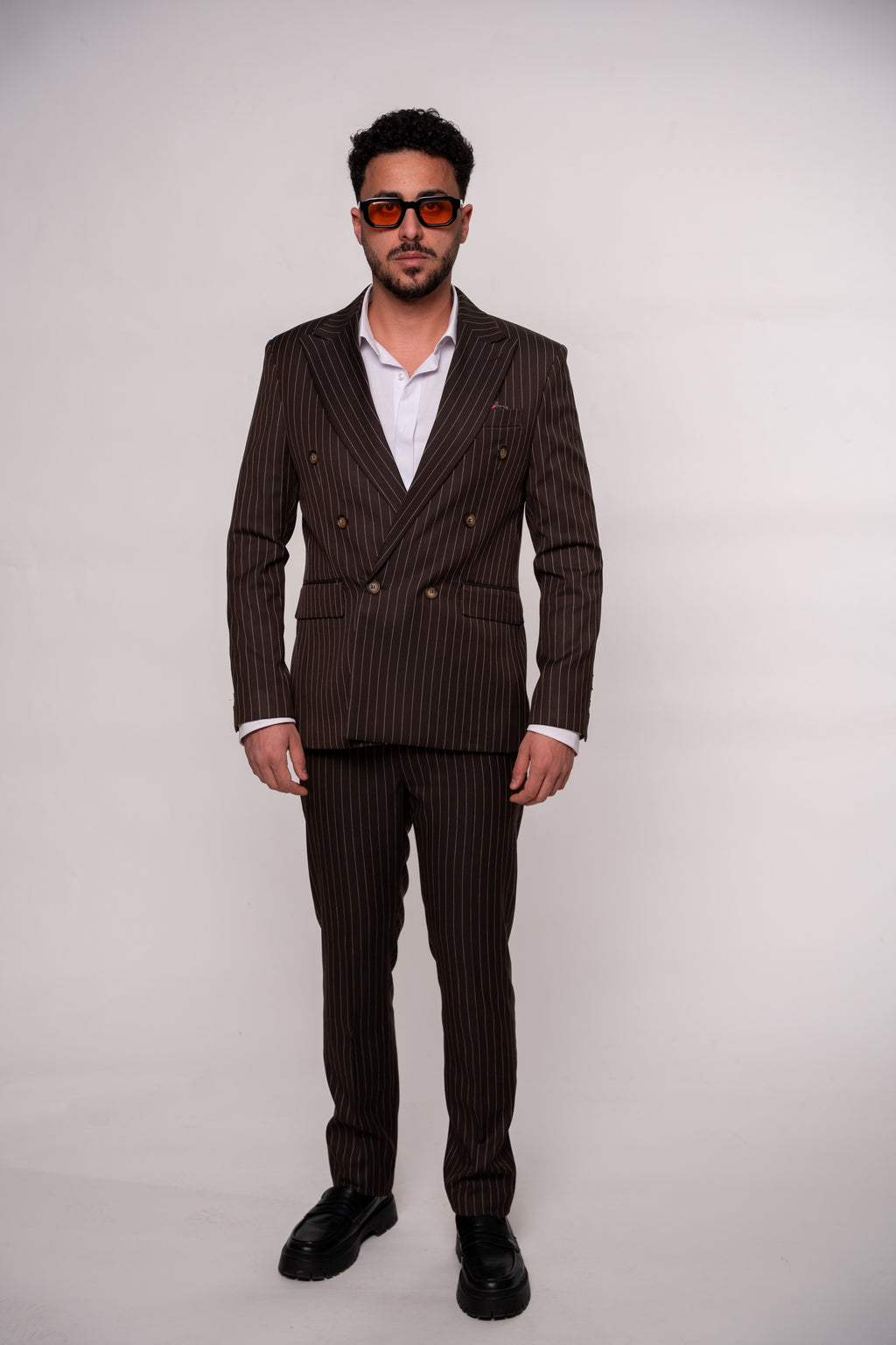 Brown striped double-breasted suit with two rows of buttons, tailored for a classic, sophisticated look by CoutureforGentlemen.