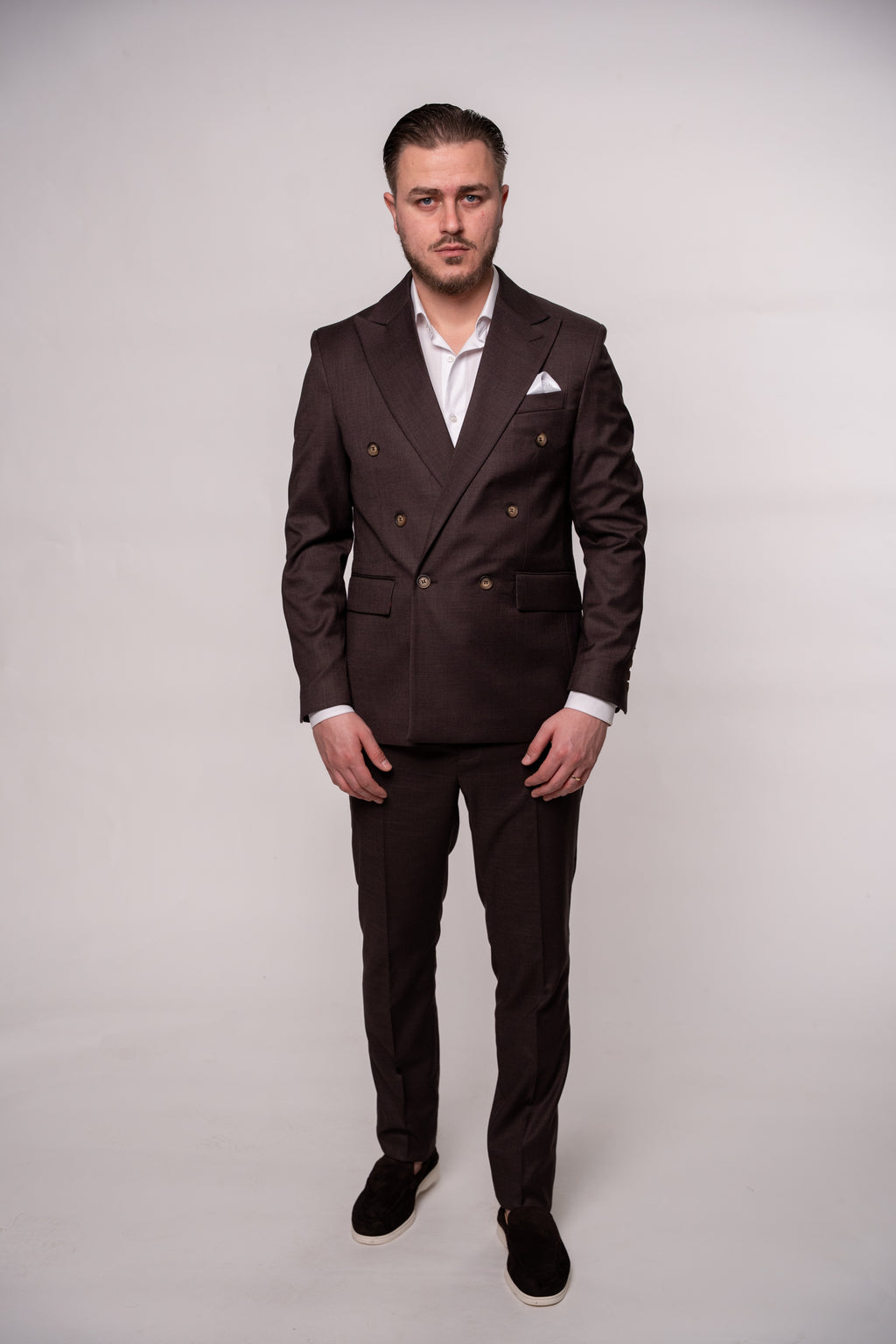 Chocolate brown Napoli two-row button suit jacket for men, shown on a mannequin with detailed fabric texture.
