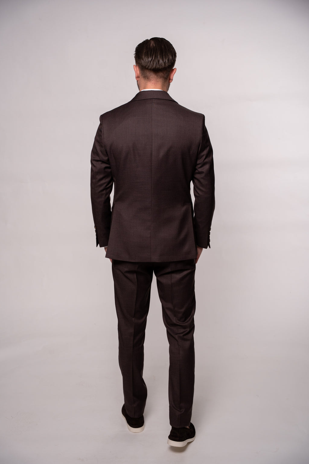 Chocolate brown Napoli two-row button suit for men, featuring detailed stitching and tailored fit, displayed on a mannequin.