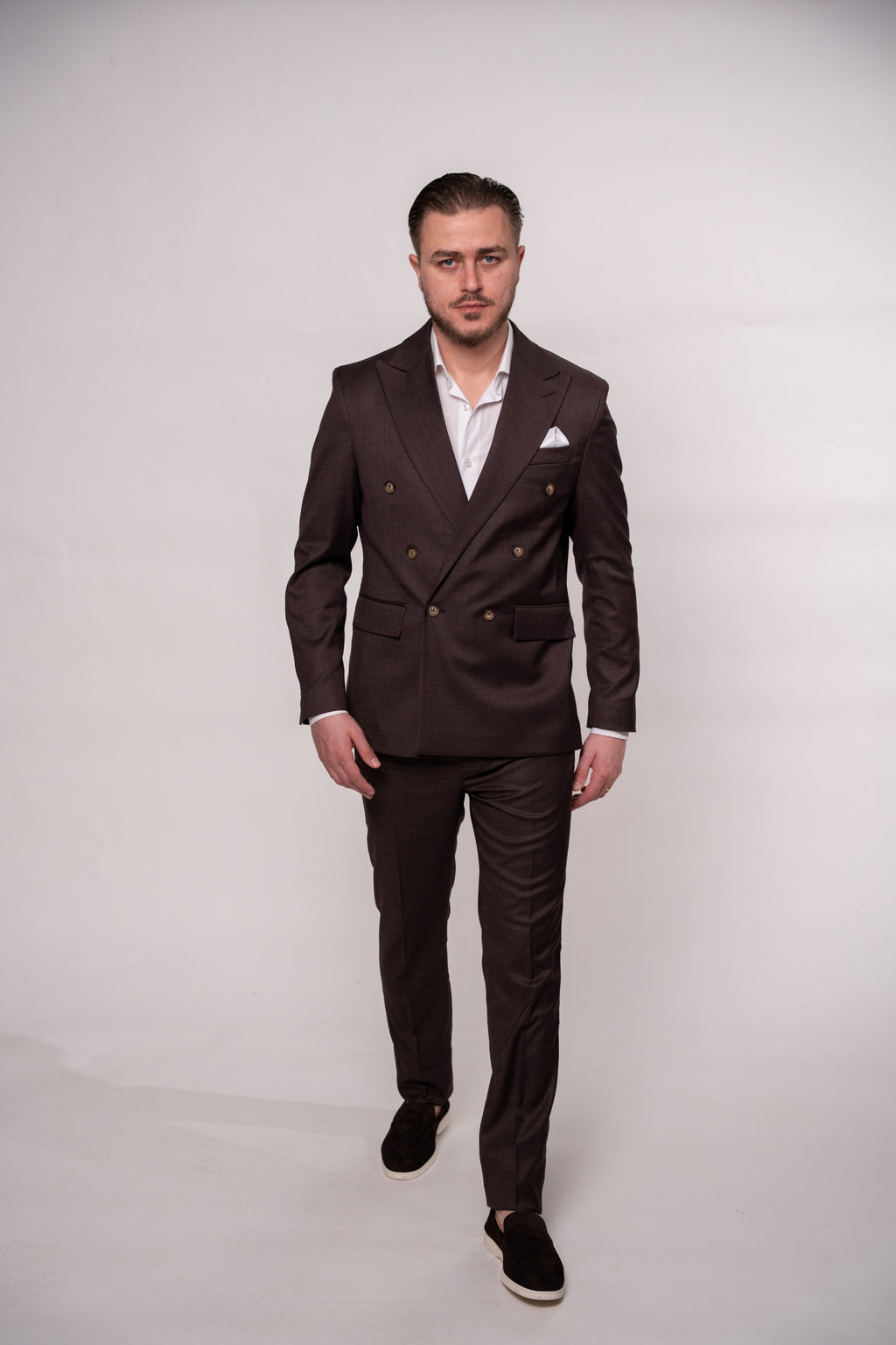 Chocolate brown Napoli-style men's double row button suit fabric close-up showing textured material and button details.