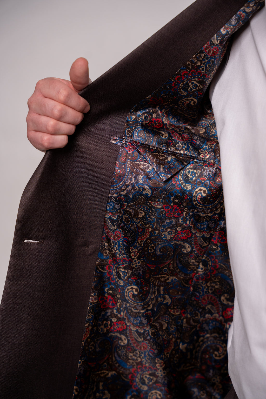 Chocolate brown Napoli double-row men's button costume with visible buttons and tailored fabric, ideal for formal wear.