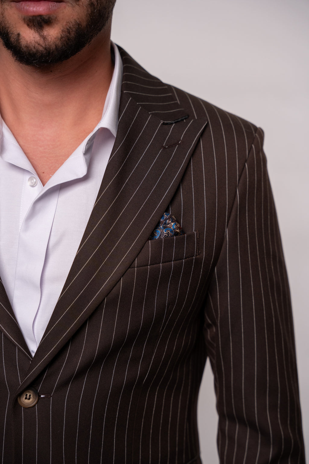 Men's brown striped suit by CoutureforGentlemen, featuring a tailored blazer with classic vertical stripes and structured fit.