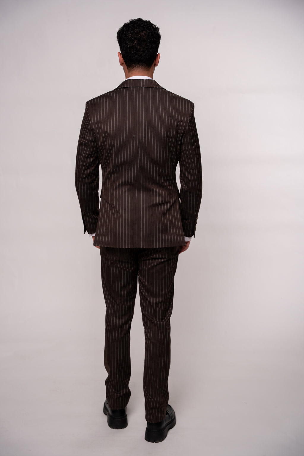 Male brown striped suit in a stylish design, featuring a tailored fit and classic pattern, perfect for formal occasions.