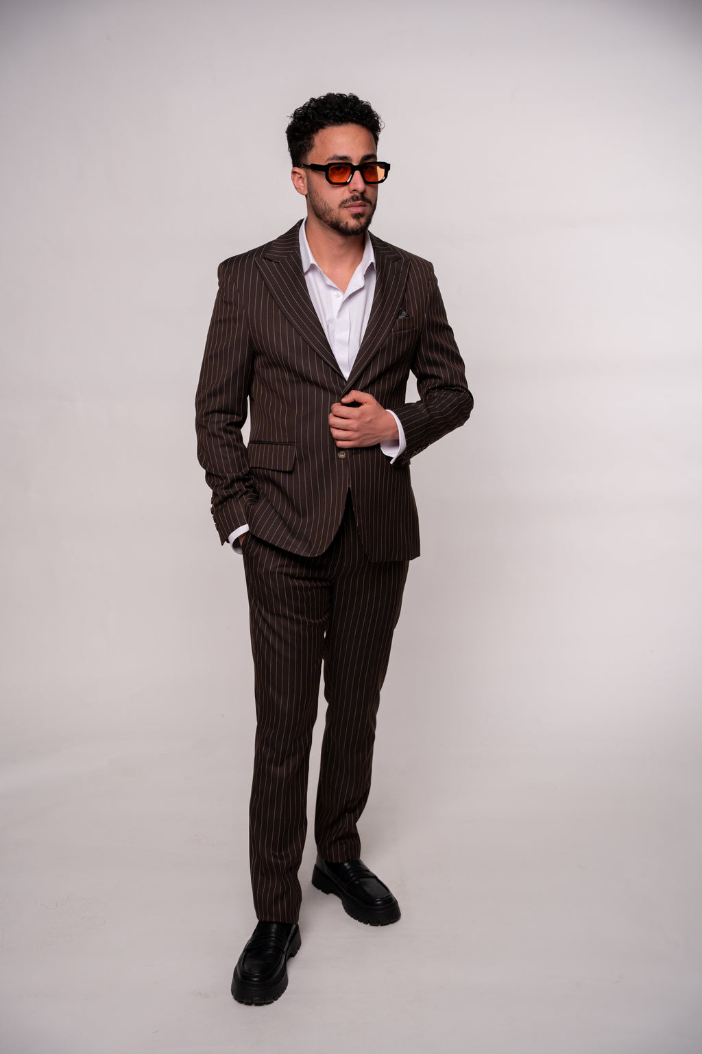 Men's brown striped costume suit with notch lapel jacket and matching trousers, stylish formal wear by CoutureForGentlemen.