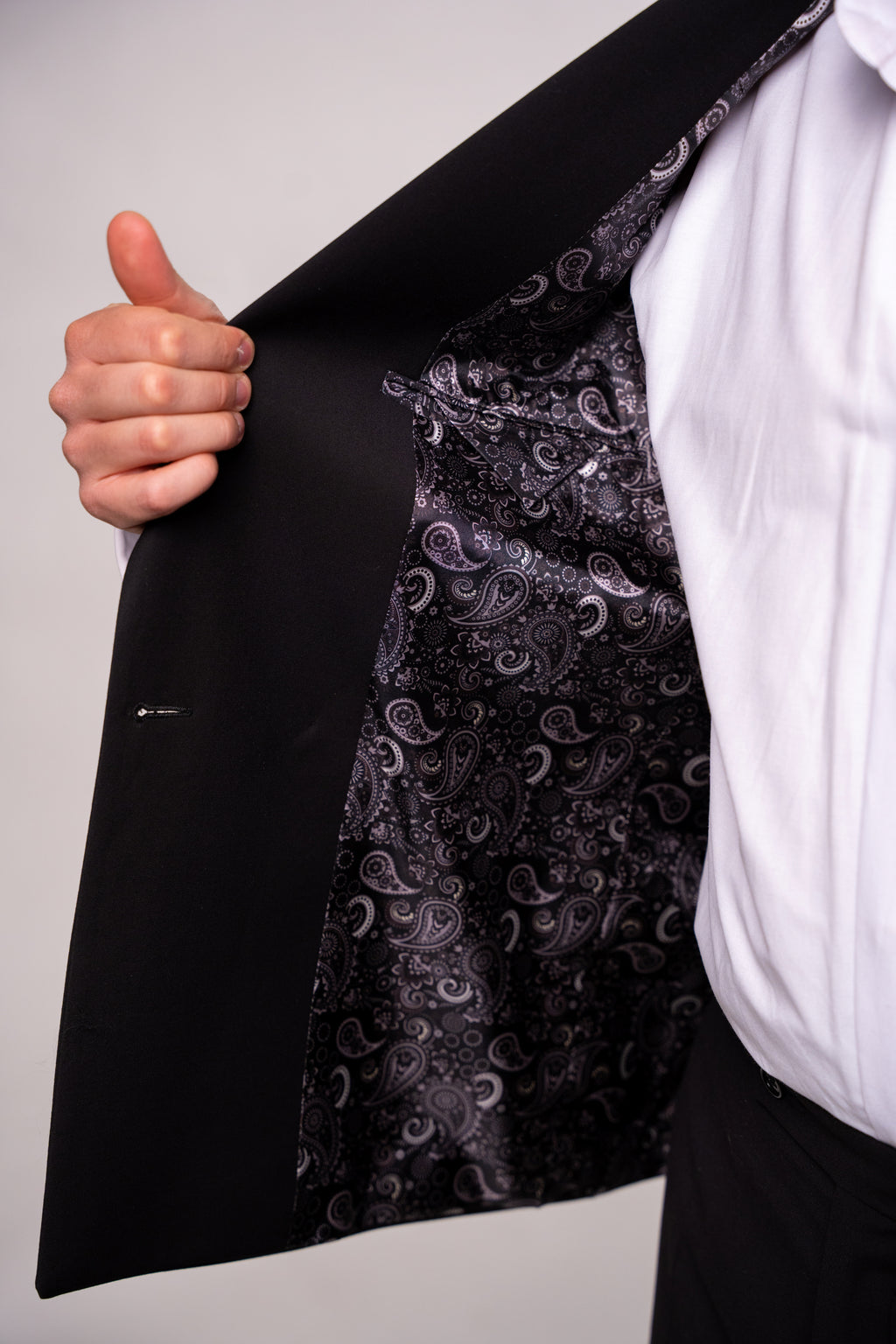 Black men's costume with two rows of buttons, tailored for a classic and elegant look, from CoutureforGentlemen.