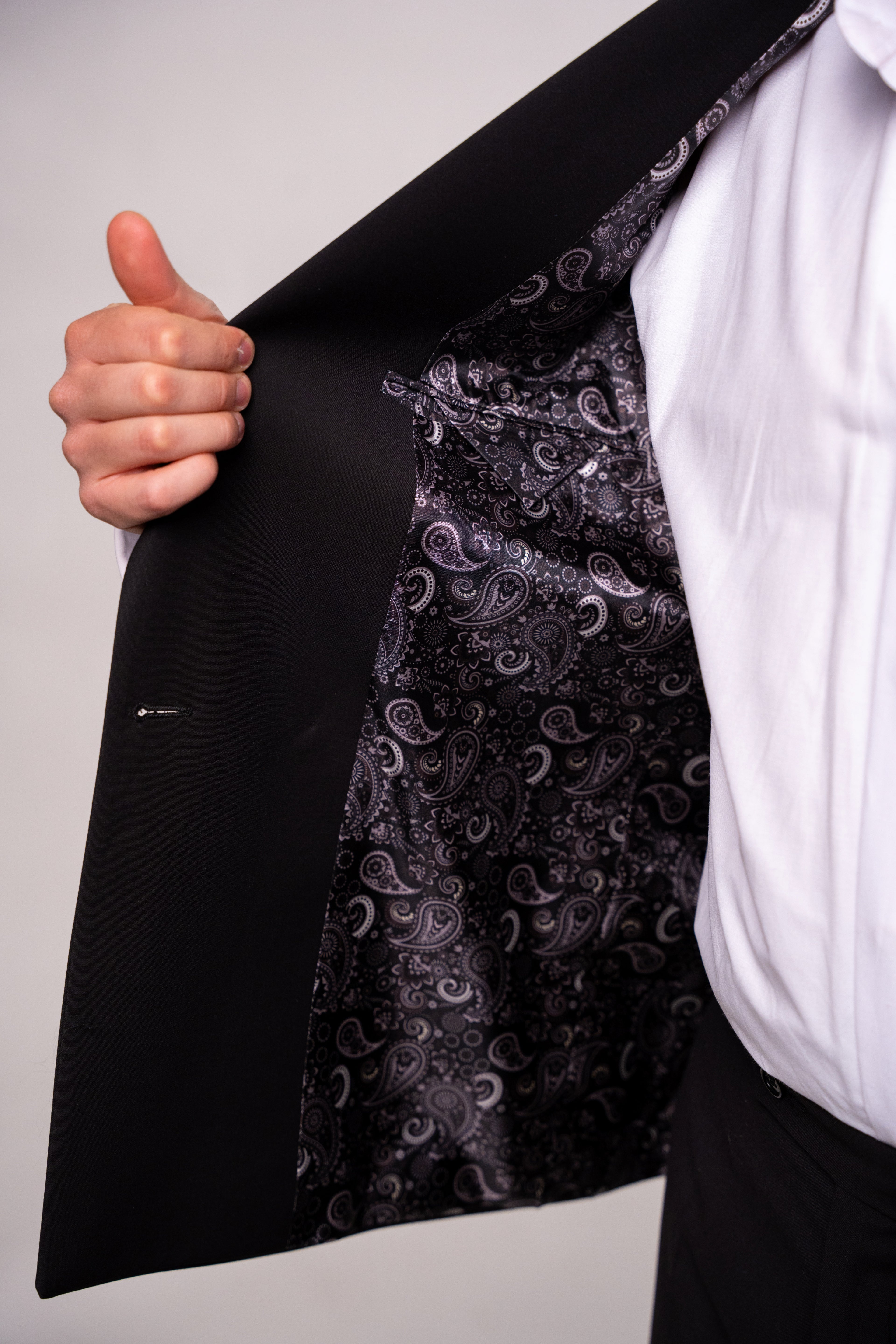 Black men's costume with two rows of buttons, tailored for a classic and elegant look, from CoutureforGentlemen.