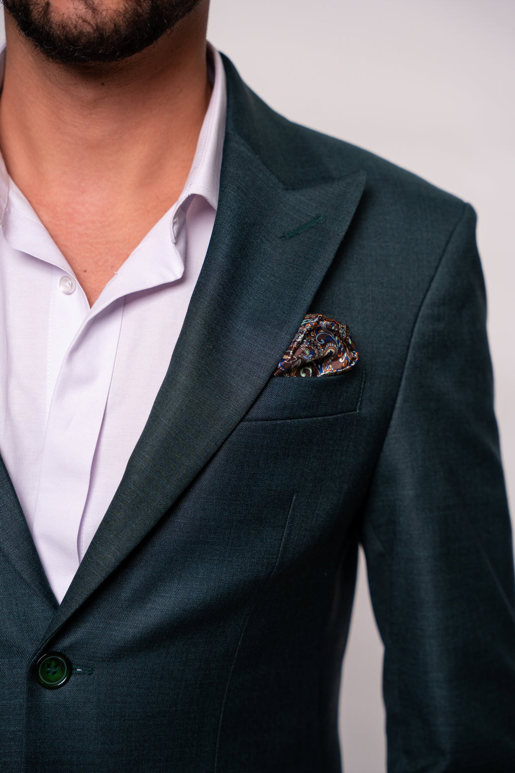 Dark green men's costume jacket from CoutureforGentlemen, stylish tailored blazer with lapels and buttons on front.