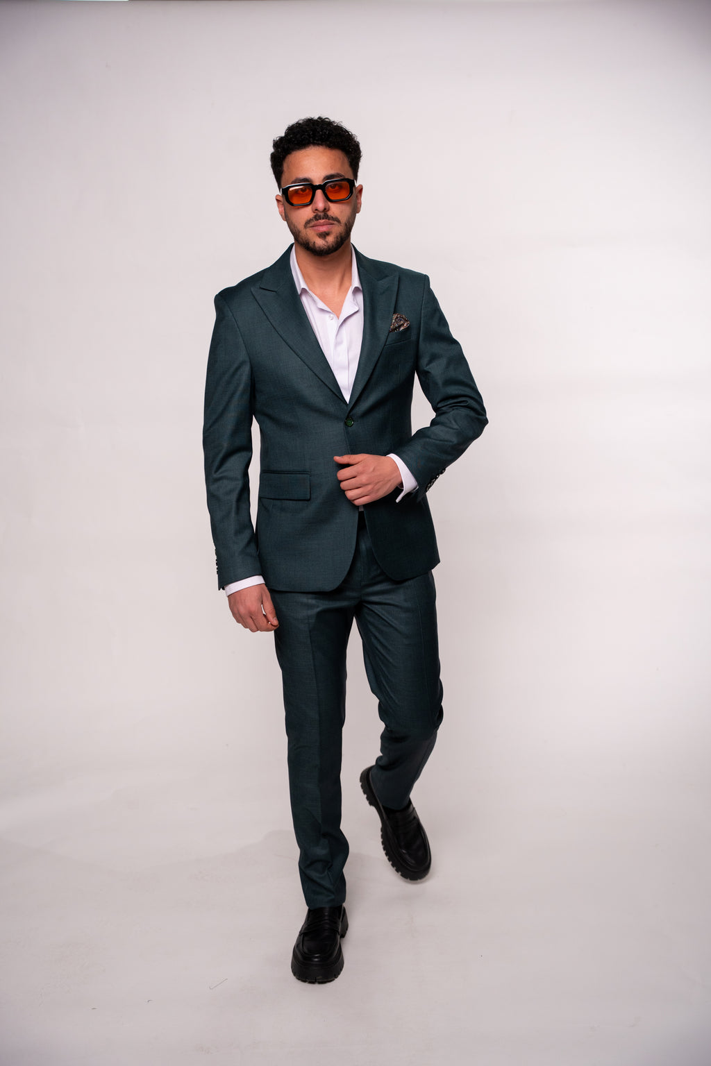 Dark green men's costume jacket by CoutureforGentlemen, tailored fit with lapels, shown on a hanger.