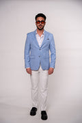 Light blue tailored fit suit jacket by Couture for Gentlemen, front view showing lapels and button details.