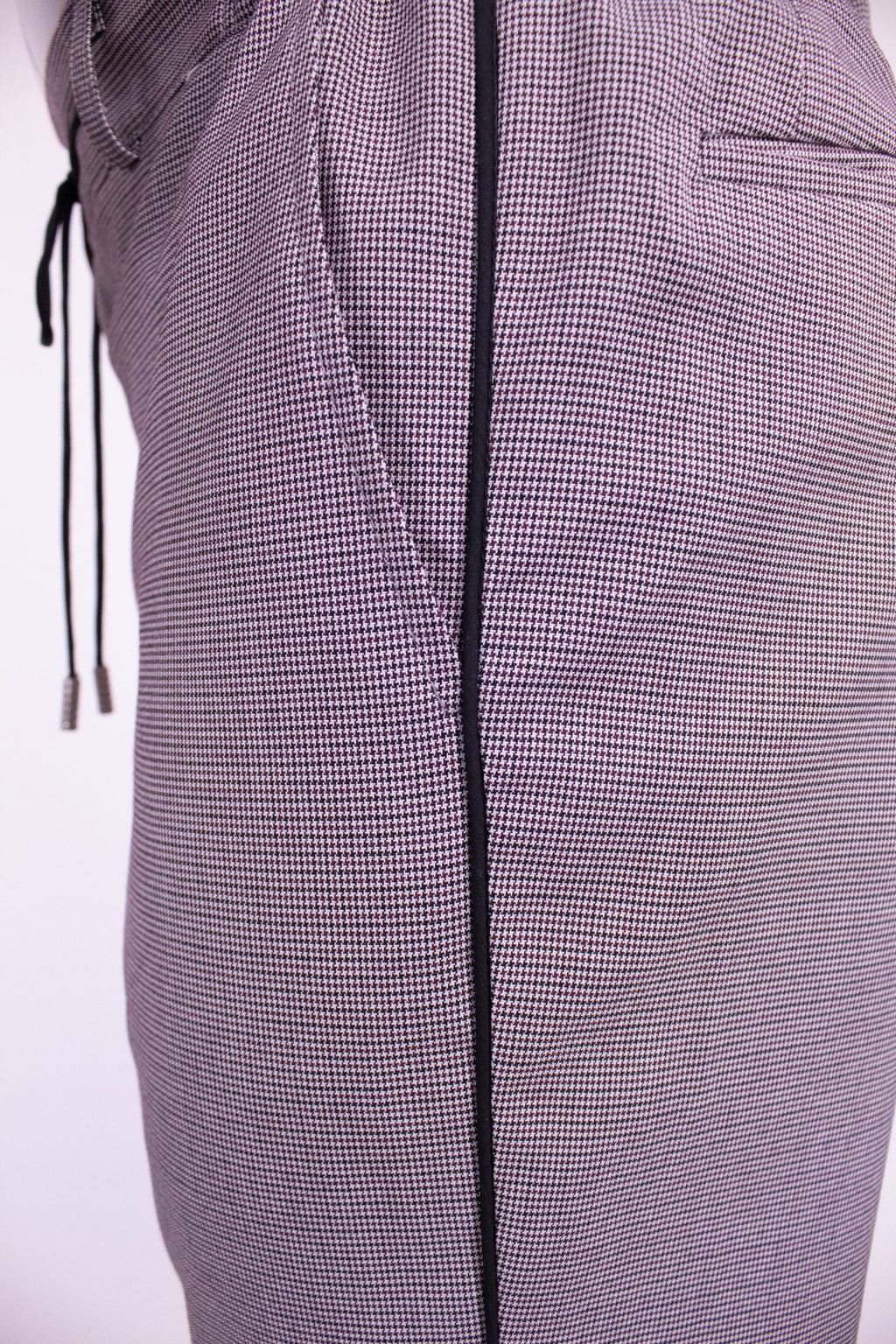 Dark indigo textured chino pants by Couture for Gentlemen, shown on a model with a close-up of fabric detail.