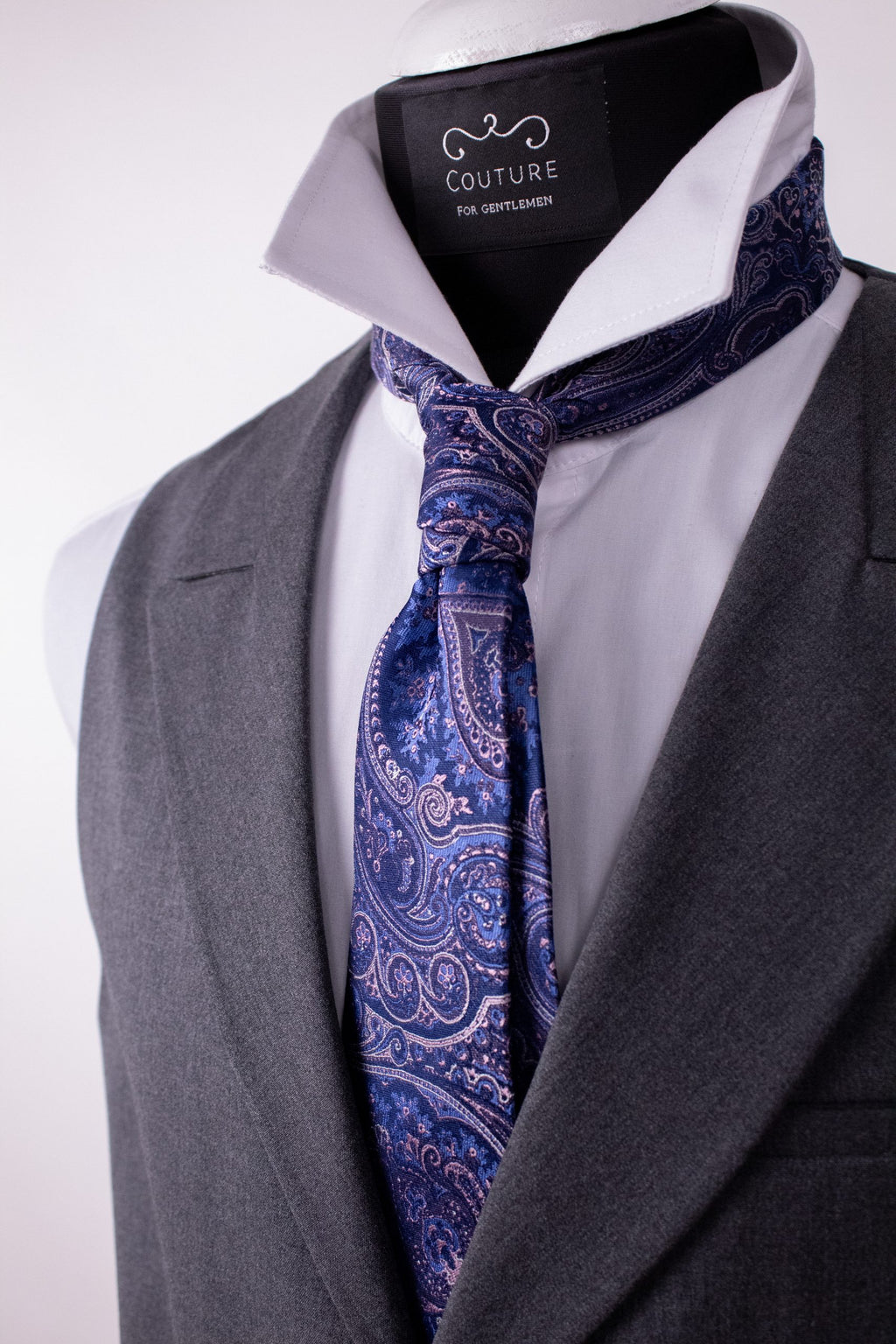 Purple silk cravat with elegant knot, showcasing luxurious natural silk fabric and refined design.