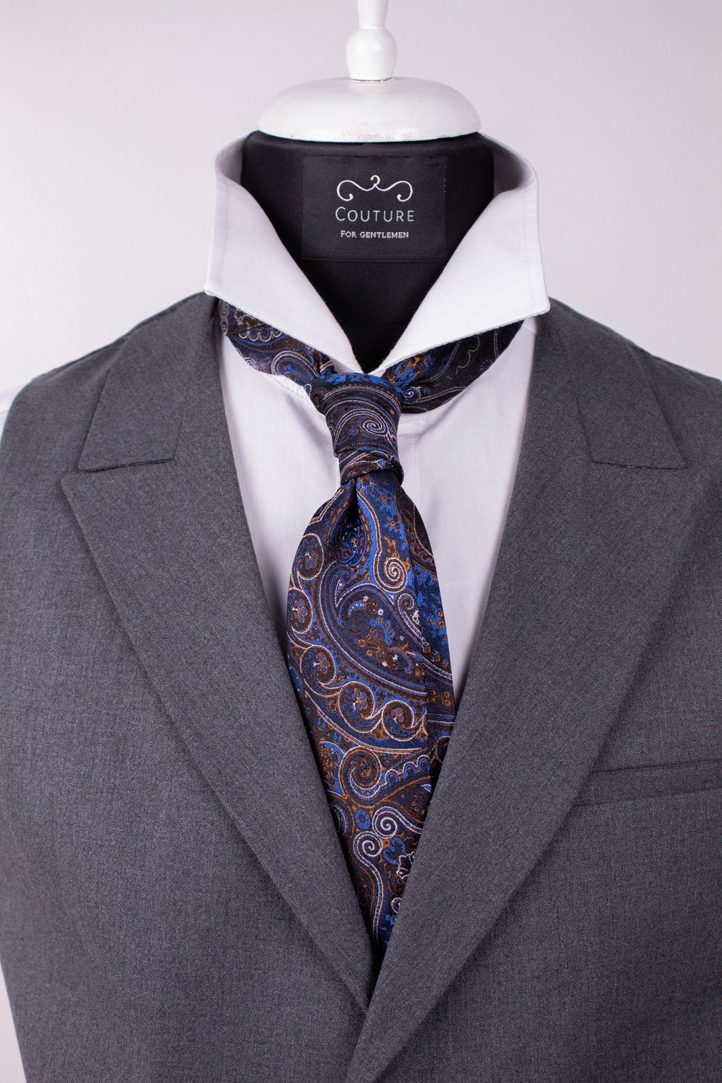 Blue floral silk cravat with intricate floral pattern, showcasing luxurious natural silk fabric and elegant design.
