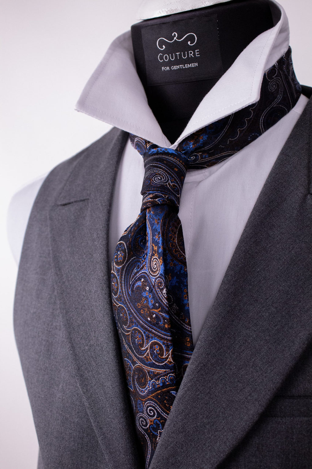 Blue floral silk cravat with intricate design, showcasing elegant craftsmanship and luxurious natural silk fabric.