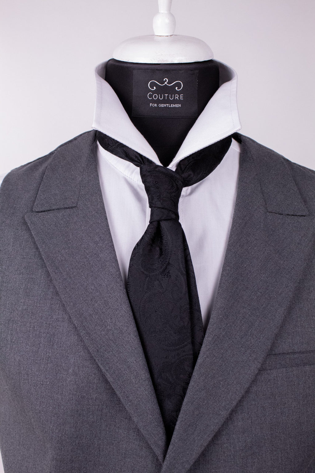 Black paisley silk cravat with intricate pattern, elegant accessory for formal men's fashion.