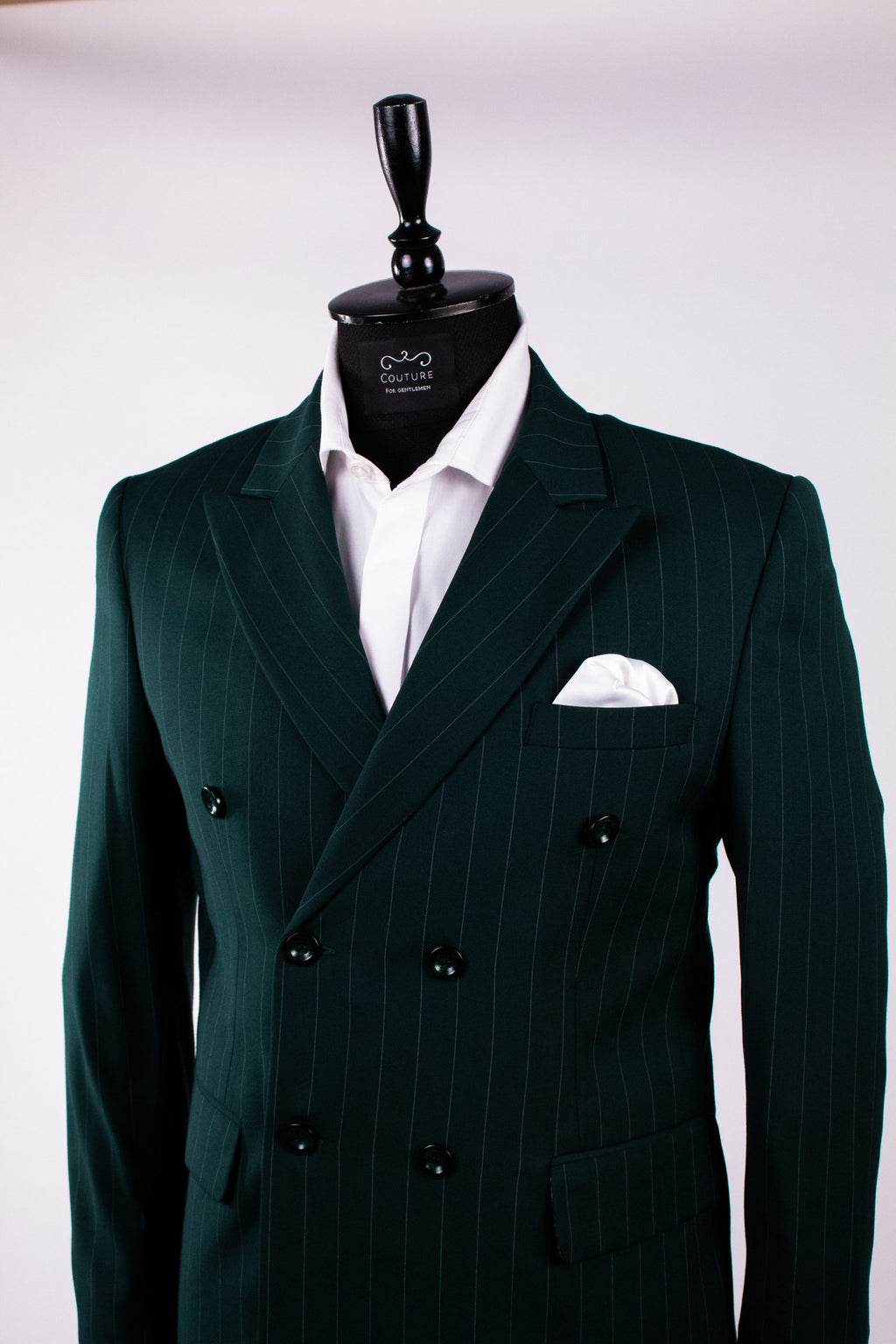 Dark green men's costume with double row buttons, tailored fit, featuring vertical stripe pattern and classic lapel design.