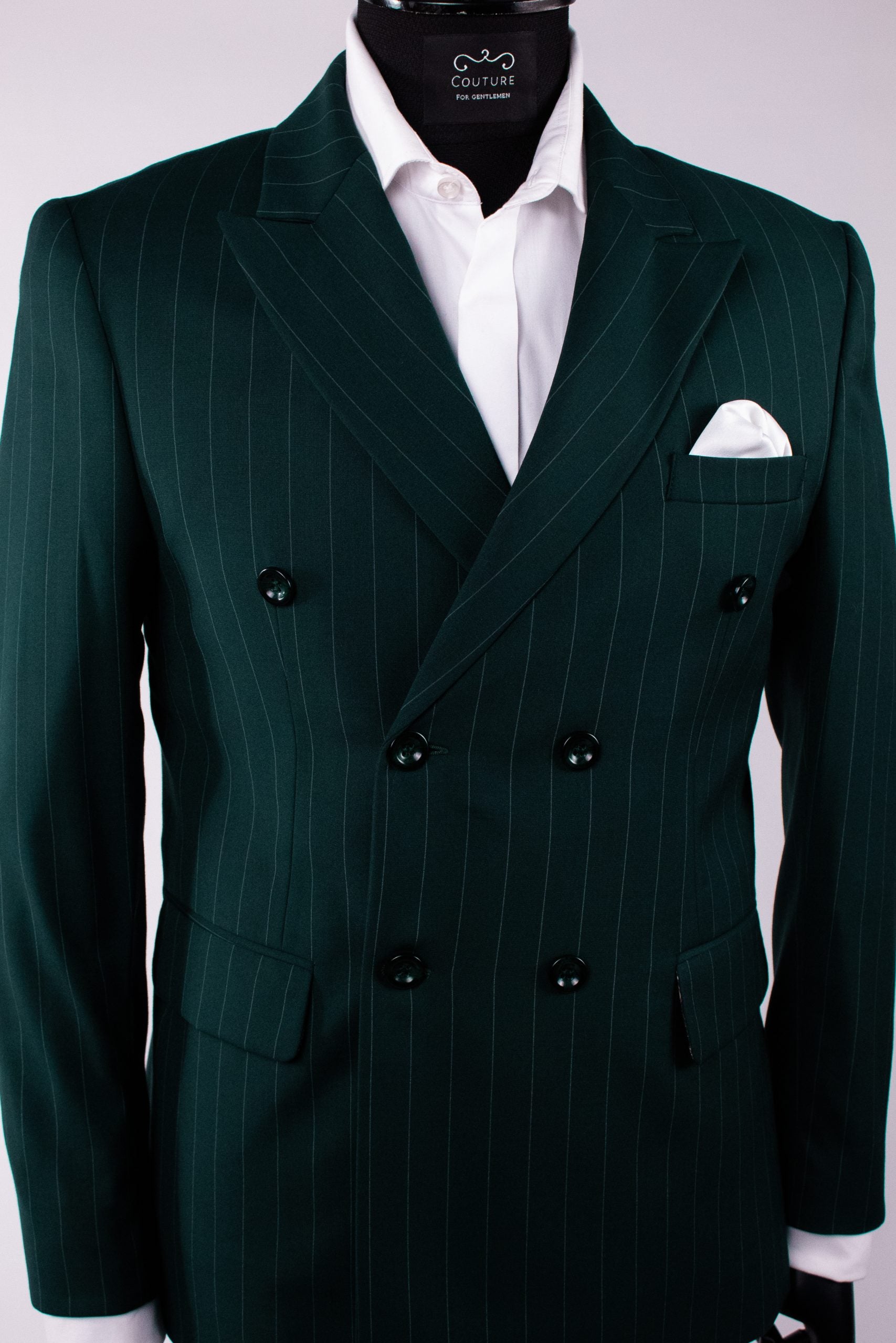 Dark green men's costume jacket with double-breasted buttons, tailored fit, featuring vertical stripe pattern and structured lapels.