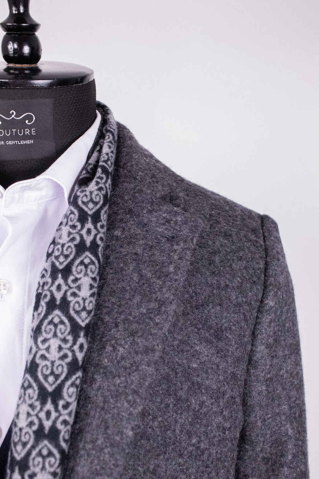 Dark gray men's coat PAR008 by Couture for Gentlemen, showing the tailored front and stylish collar detail.