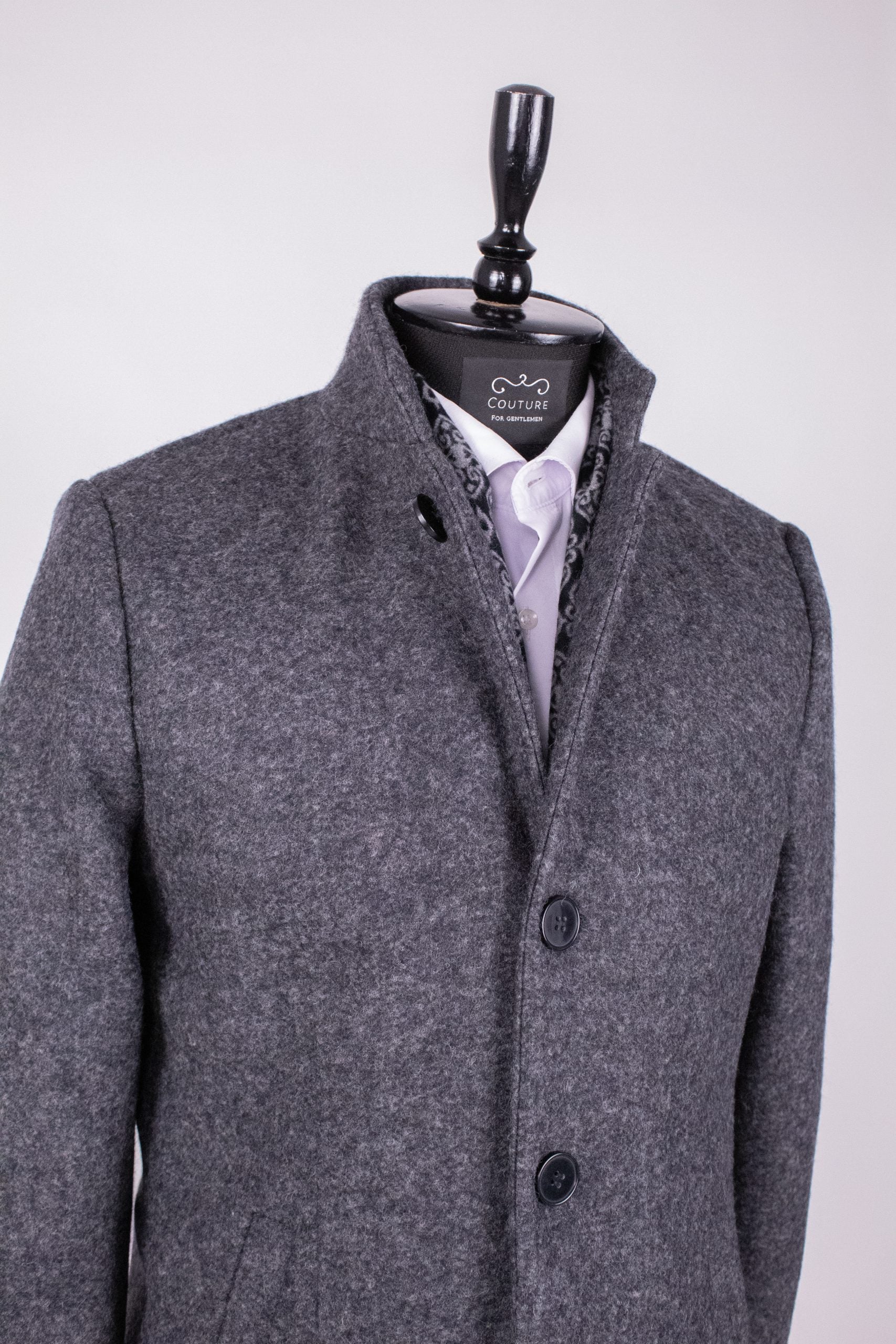 Dark gray men's coat PAR008 by Couture for Gentlemen, shown hanging with detailed fabric texture.